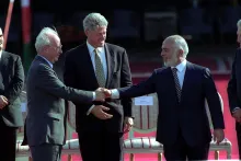 King Hussein of Jordan shaking hands with Israeli Prime Minister Yitzhak Rabin as President Bill Clinton looks on during the Israel-Jordan peace era