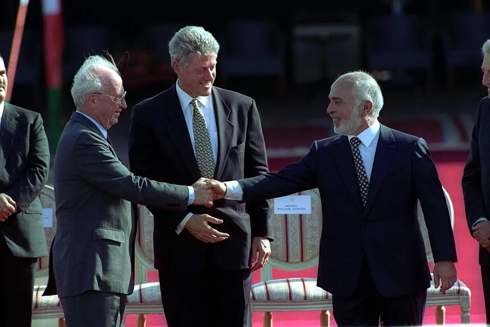 King Hussein of Jordan shaking hands with Israeli Prime Minister Yitzhak Rabin as President Bill Clinton looks on during the Israel-Jordan peace era